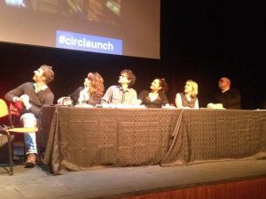 An author panel sit stunned as their writing story gets projected above their heads....